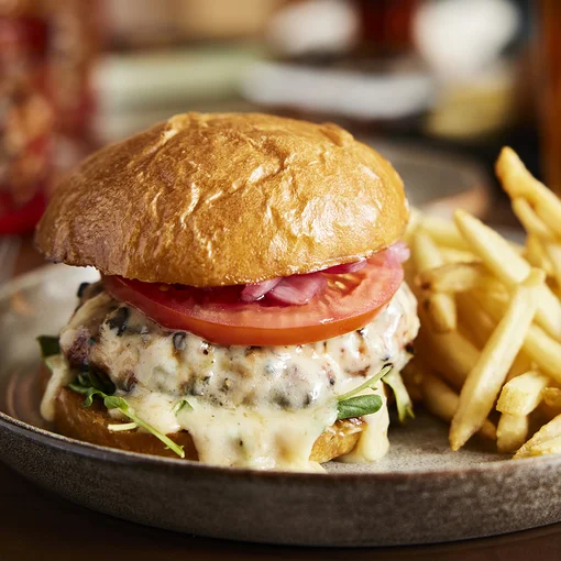Delicious burger with fries on plate