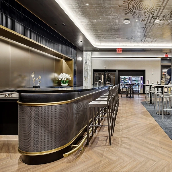 Bar setting with high chairs lined along the front