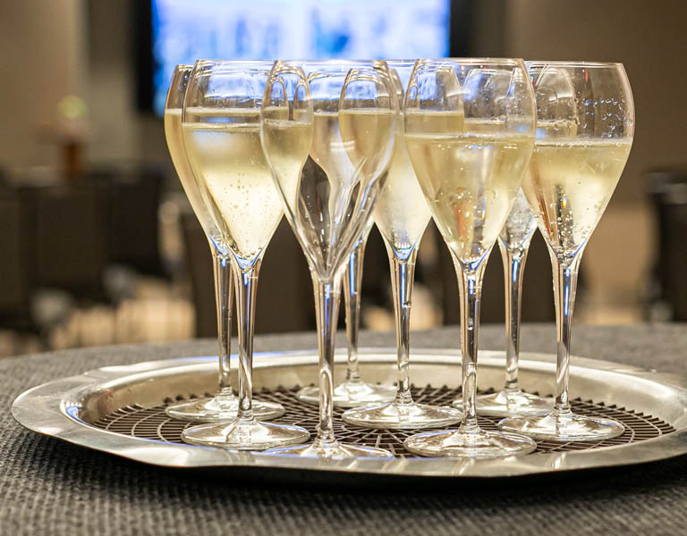 Tray of glasses filled with white wine