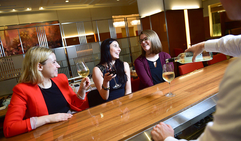 Guests enjoy cocktails at STATE grill and bar at the Empire State Building